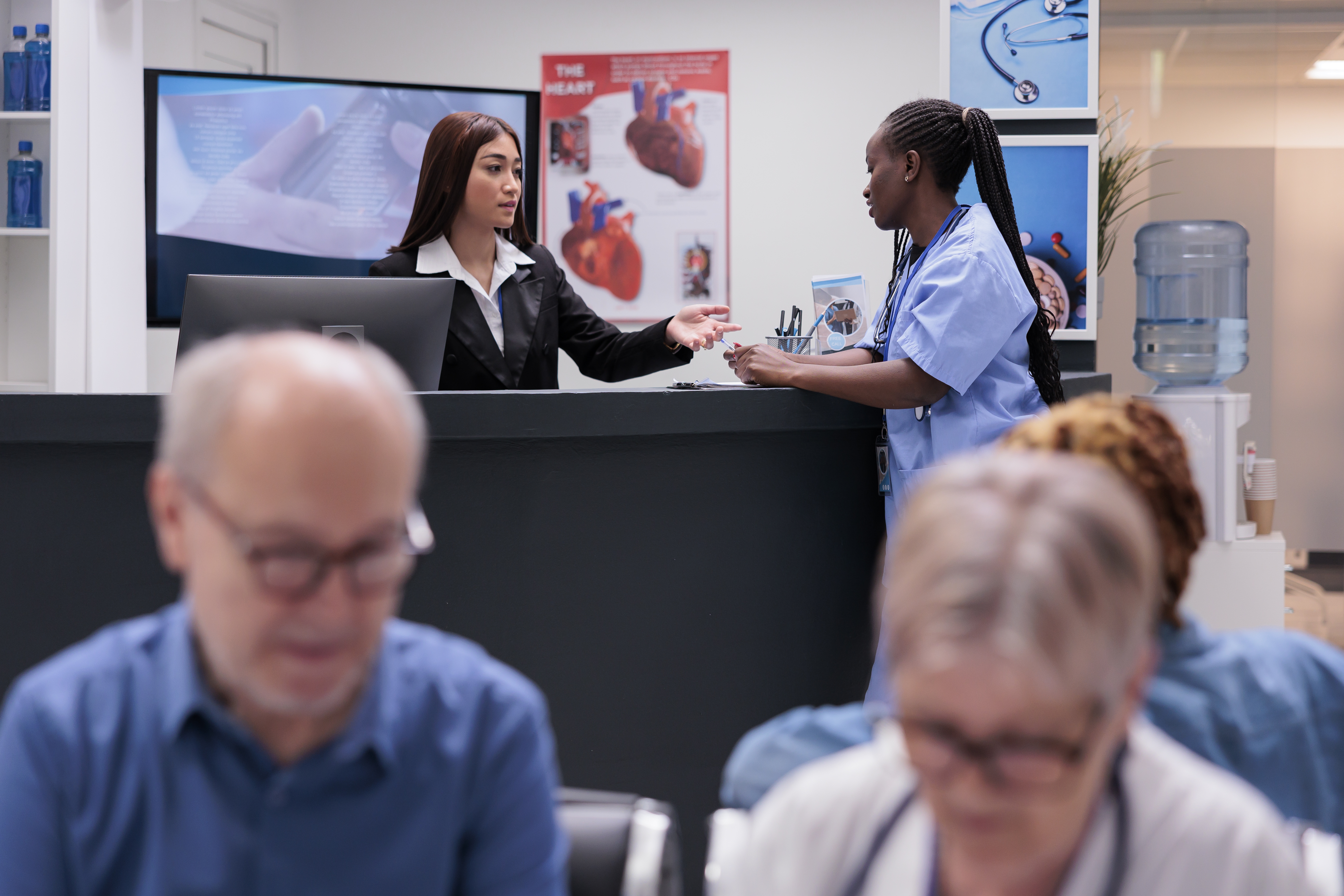 Diverse medical staff working at reception counter